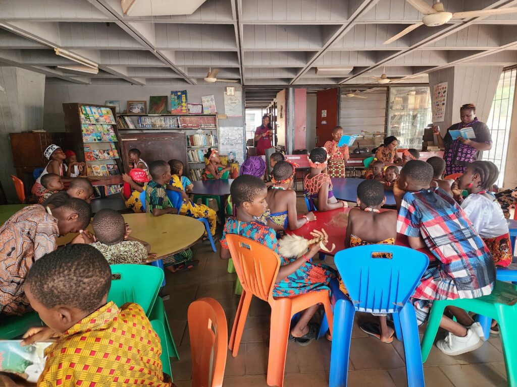 Shots of children and librarians sharing stories in their mother tongue at the Onitsha Divisional Library, Nigeria
